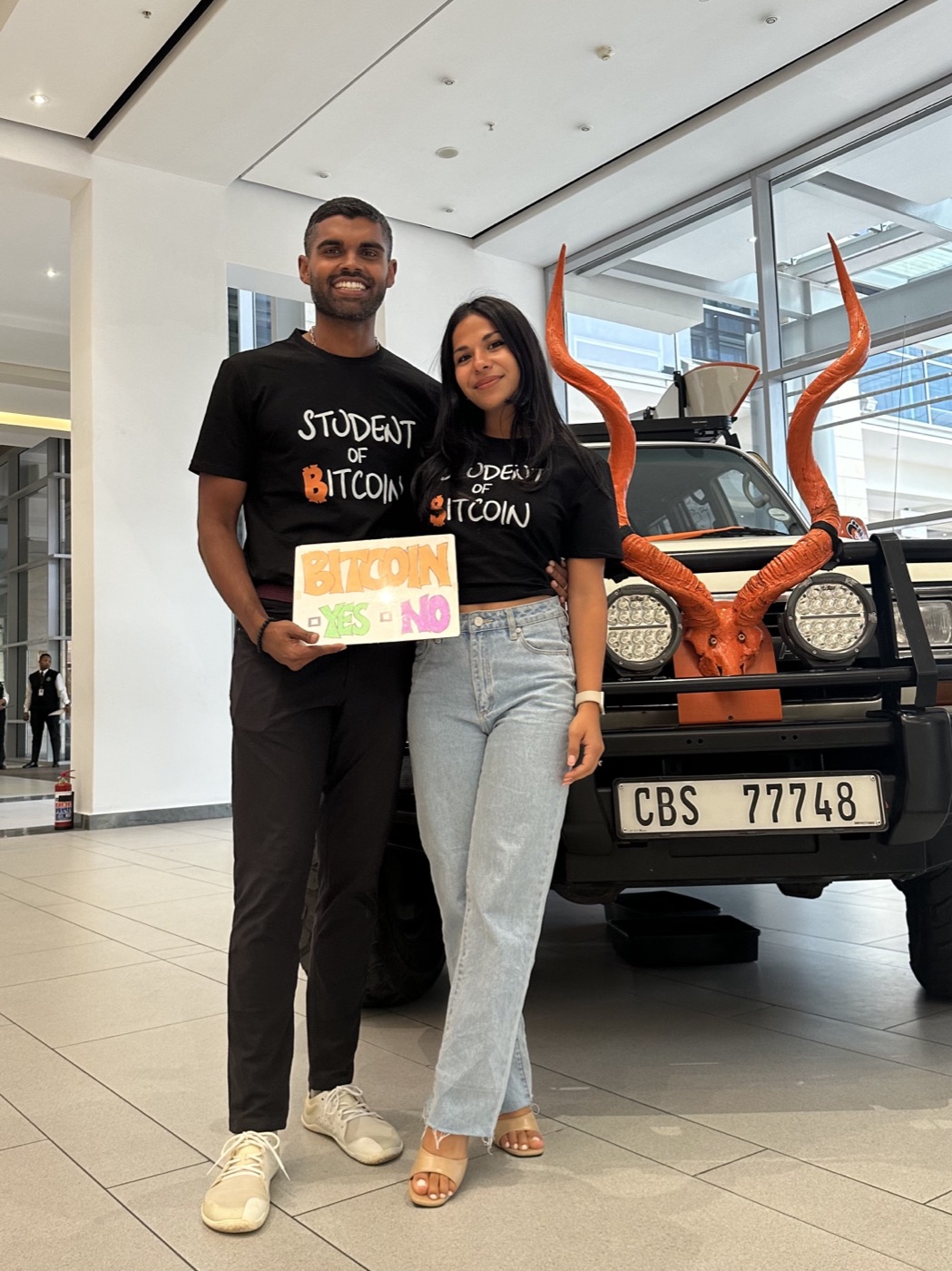 Santosh at Adopting Bitcoin, Cape Town, 2024, holding a hand-drawn 'Bitcoin: yes or no' sign