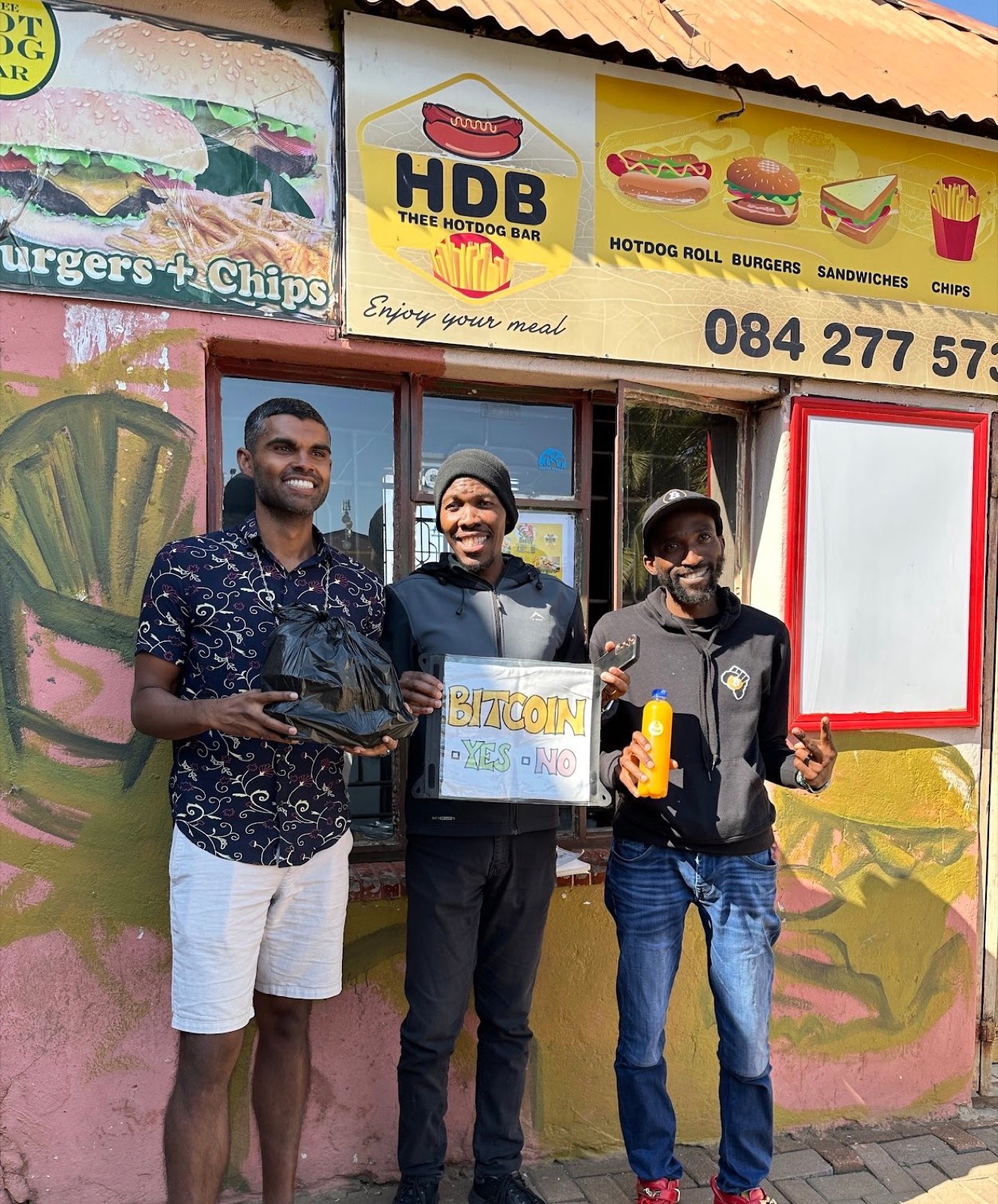 The fast-food vendor and his stand, HDB Thee Hotdog Bar, after pricing an order in satoshis